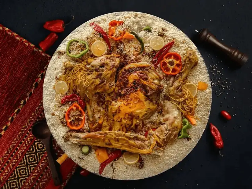 Traditional feast with roasted chicken over a bed of flavored noodles.