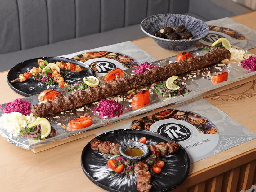 Elegant display of kebabs and sides, perfect for a group dining experience.