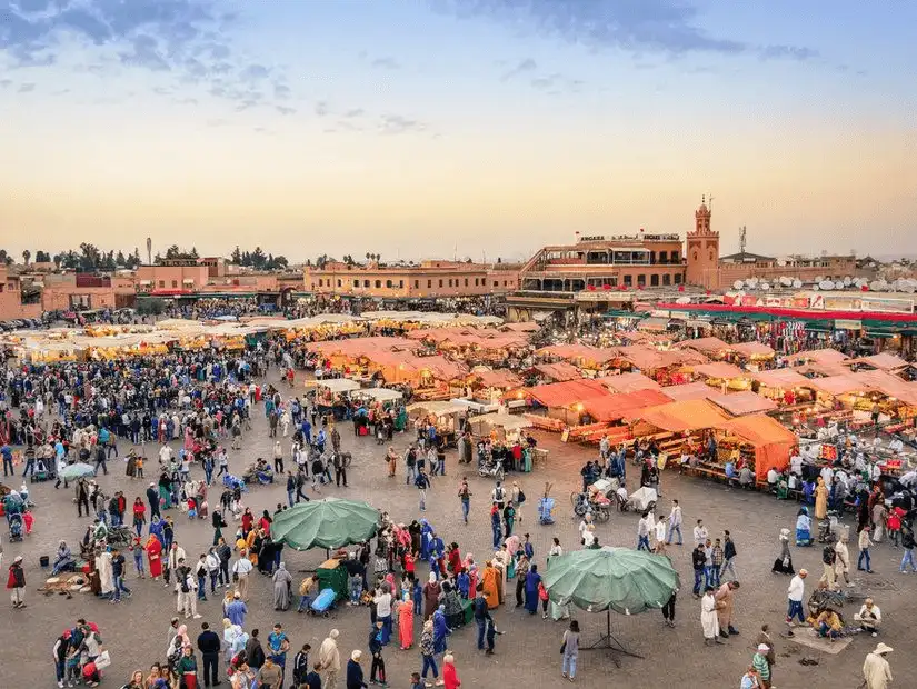 The bustling Jemaa el-Fnaa square, filled with vibrant market stalls and entertainers.