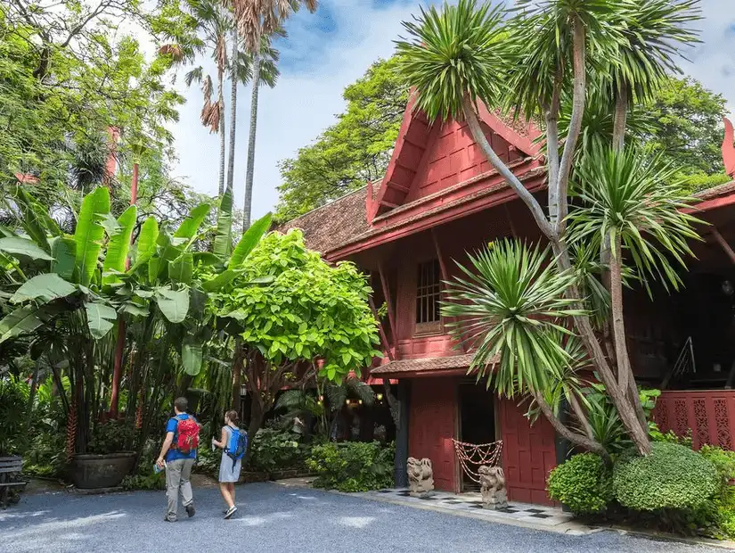 The lush greenery surrounding the traditional architecture of Jim Thompson House Museum.