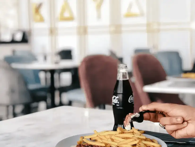 fries and a soft drink served in a stylish café.