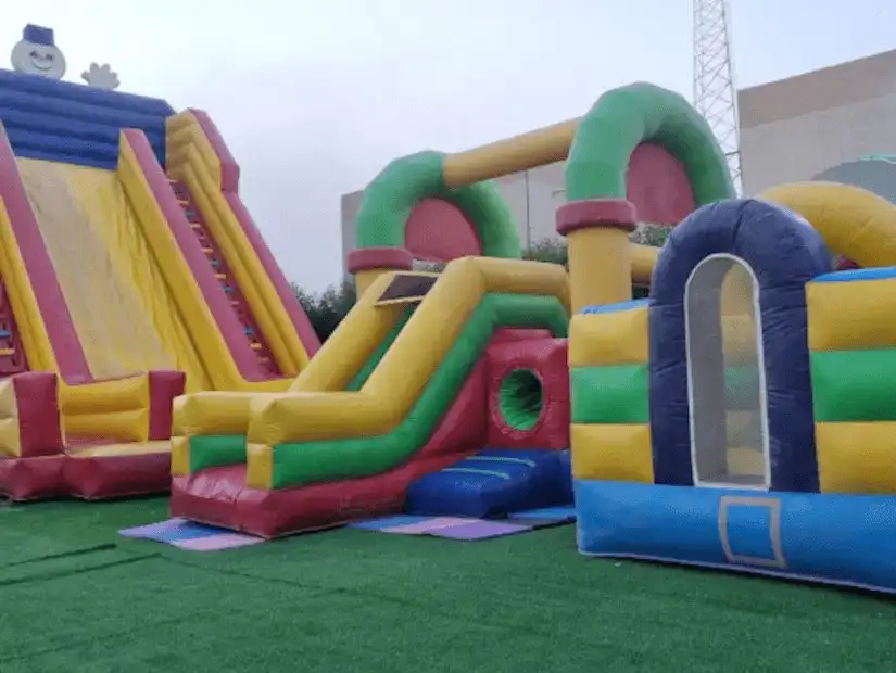 Colorful inflatable play structures at a children's amusement park in Khafji.