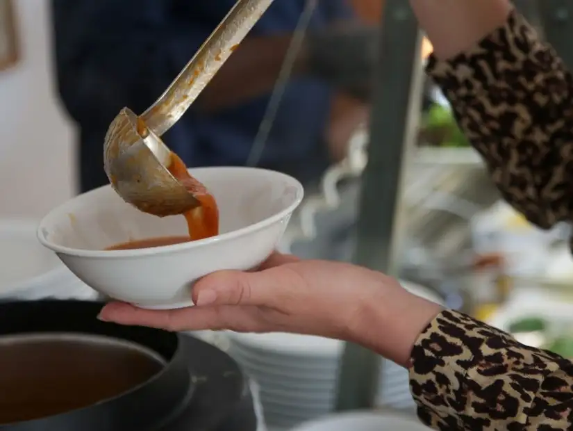 Pouring soup into a bowl