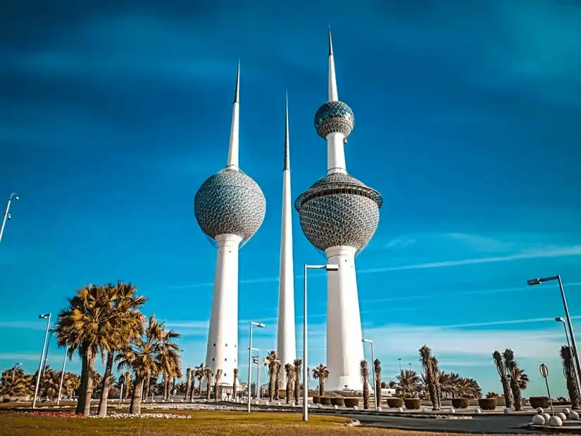 The iconic Kuwait Towers standing tall against a clear blue sky.