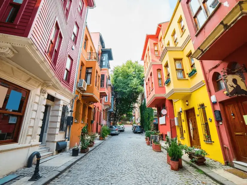 A charming residential street in Kuzguncuk, Istanbul, with colorful houses and tree-lined pathways.