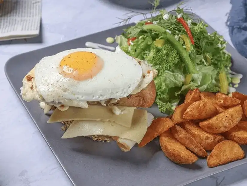 A delectable plate of eggs benedict accompanied by seasoned potatoes at LaPate Lounge.