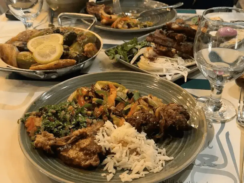 A plate featuring tender grilled meat, rice, and flavorful accompaniments.