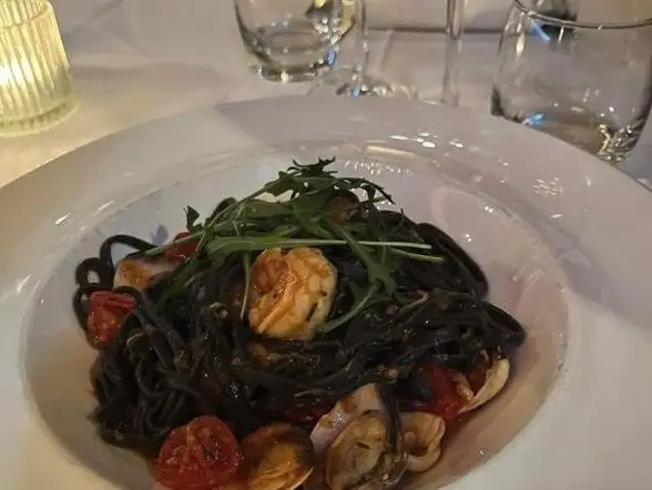 Squid ink spaghetti tossed with fresh seafood, delivering a taste of the ocean.