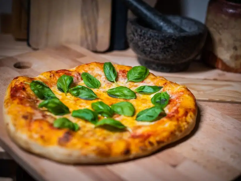 Savory pizza garnished with basil.