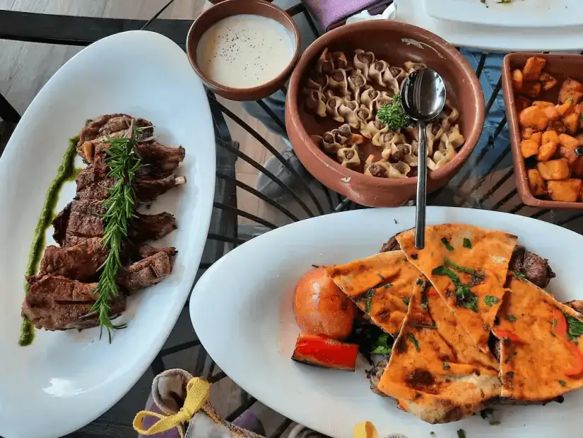 A hearty meal with grilled meat, rice, and a side of sauces, ready to enjoy.