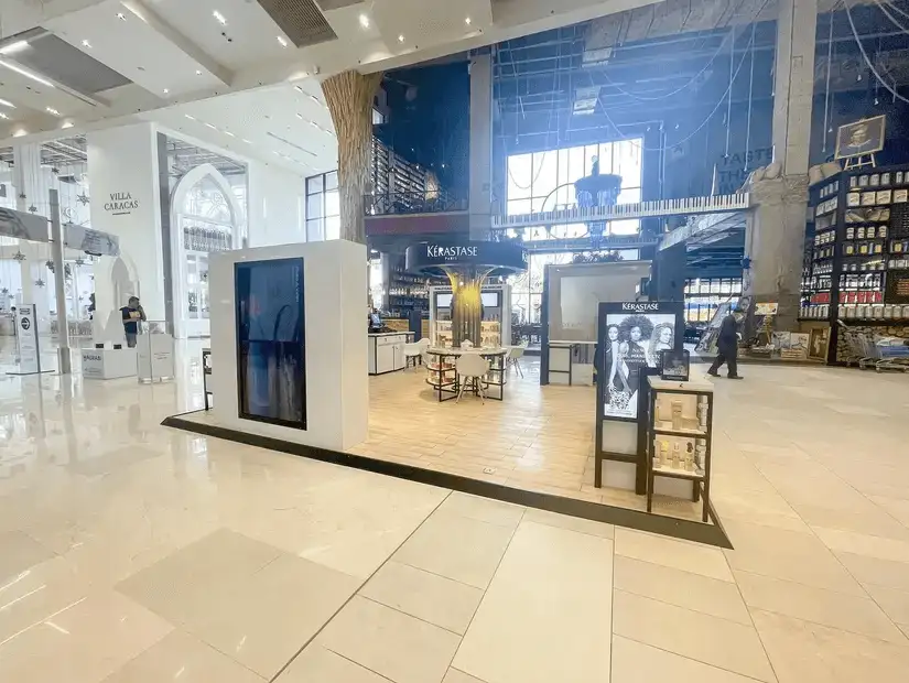 Bright and spacious interior of a shopping mall with various stores.