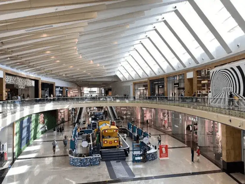 A bright and spacious interior view of Mall of Arabia, showing the upper and lower levels with modern architecture.