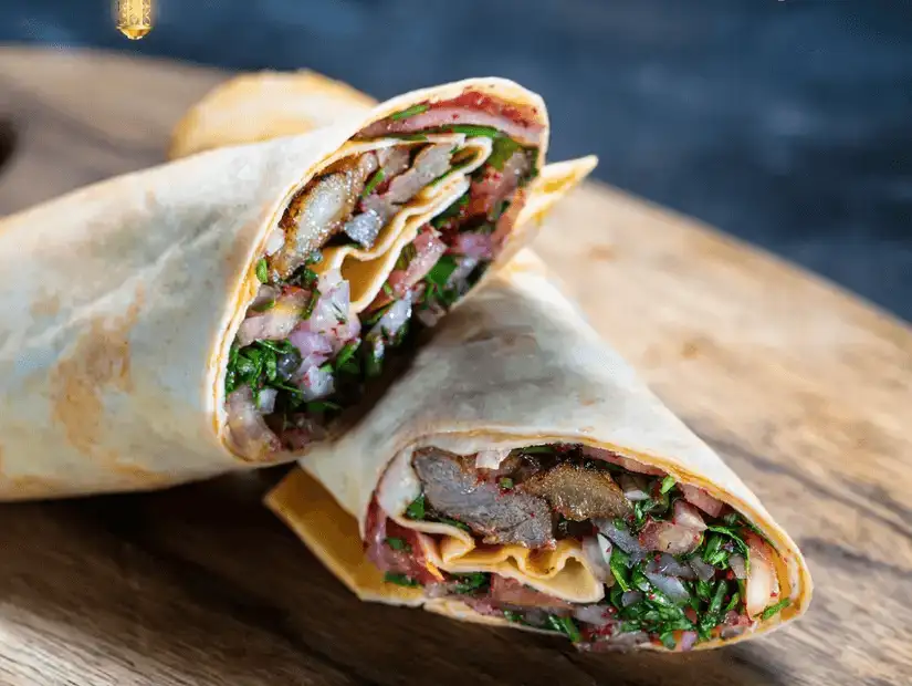 A rich and creamy dish served with aromatic rice, garnished with herbs.