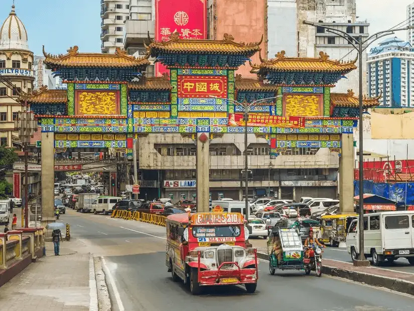 Chinatown Gate in Manila with vibrant street activity.