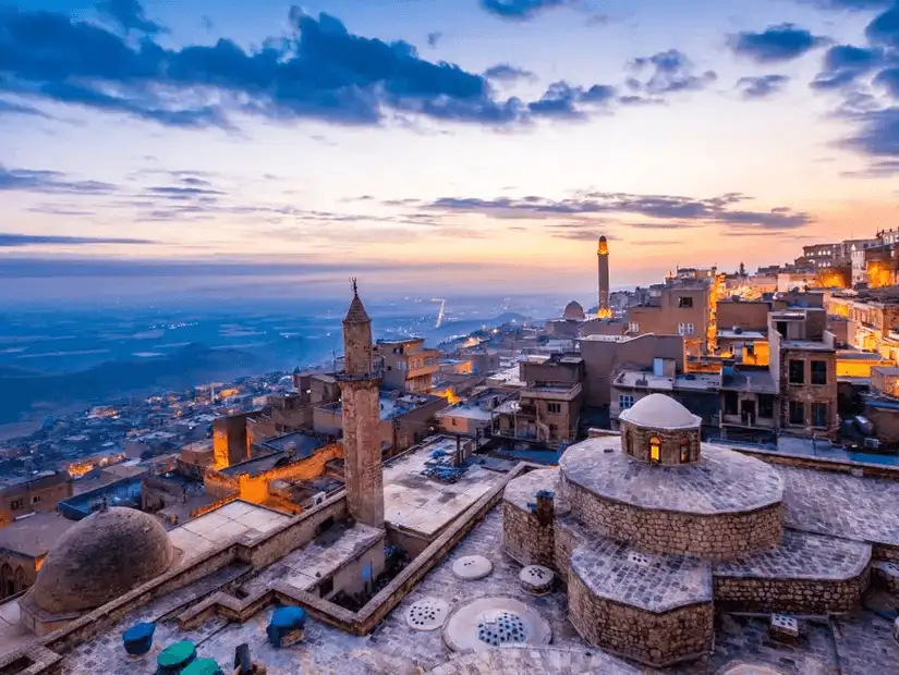 A breathtaking sunset over the ancient city of Mardin, with its stone houses and minarets.