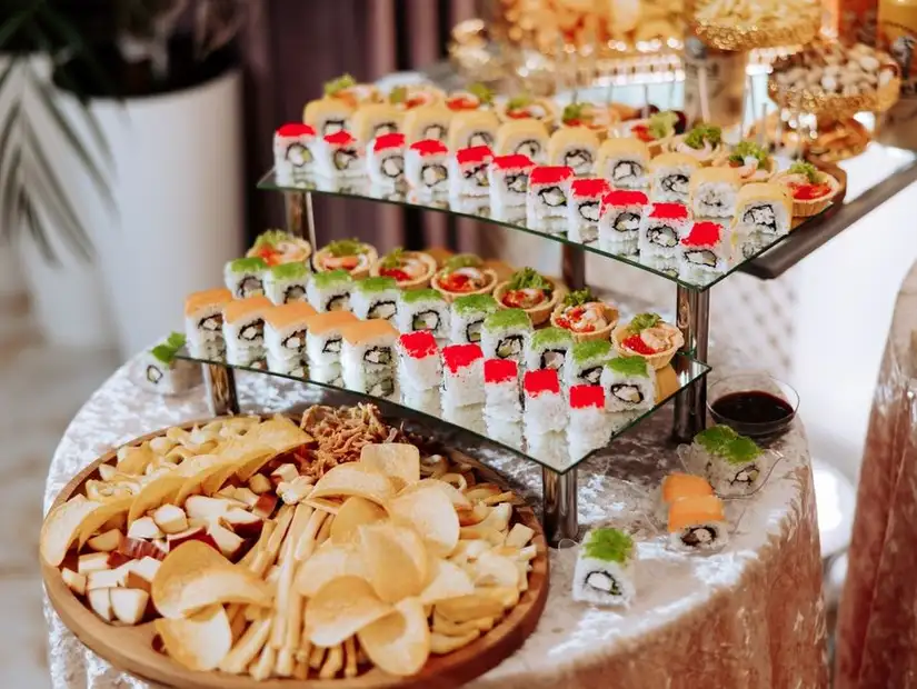 An array of sushi rolls and snacks on a table