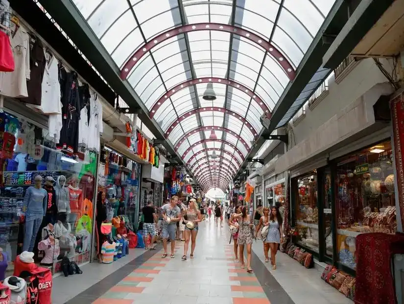 A bustling shopping street in Marmaris with colorful shops and crowds of tourists.