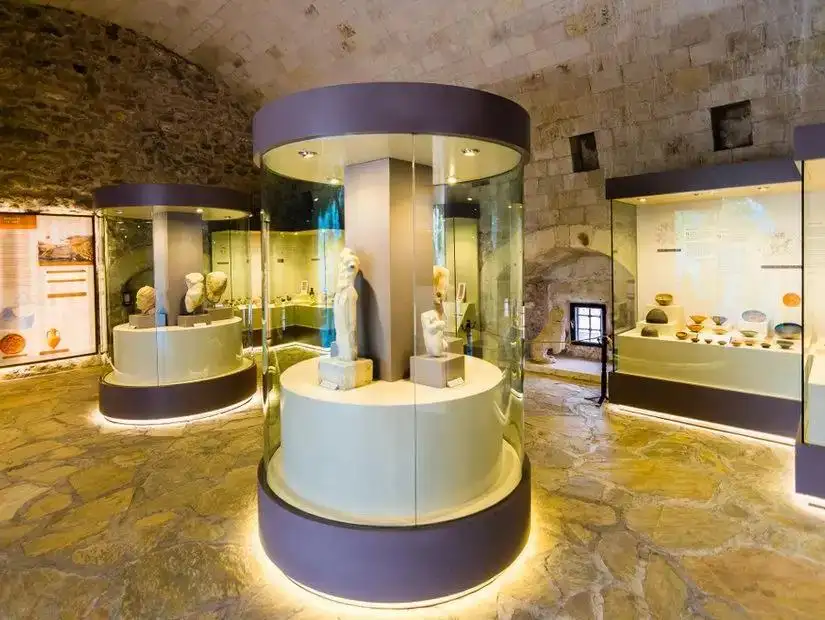 The interior of the Marmaris Museum showcasing ancient artifacts and sculptures.
