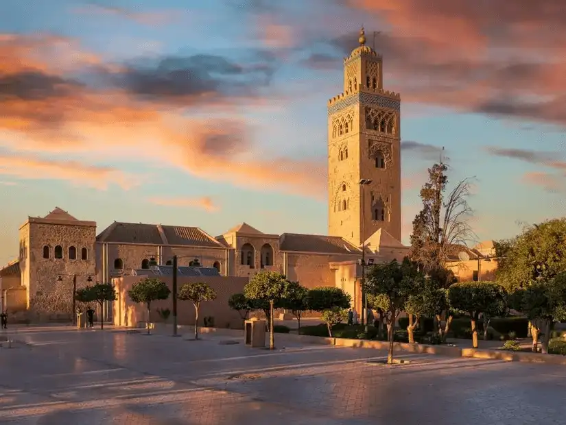 Koutoubia Mosque in Marrakesh at sunset with a vibrant sky.