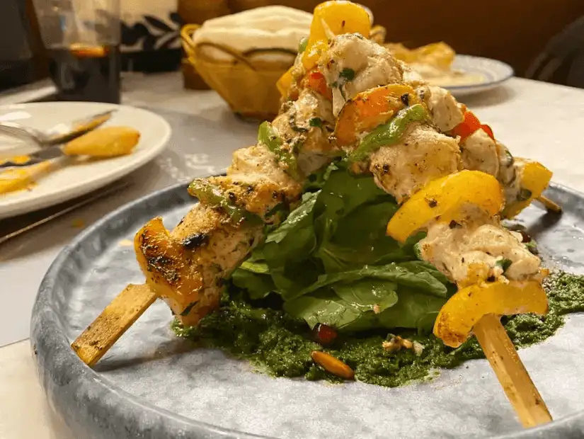 A traditional dish with tender meat and aromatic rice, served with sides of salad.