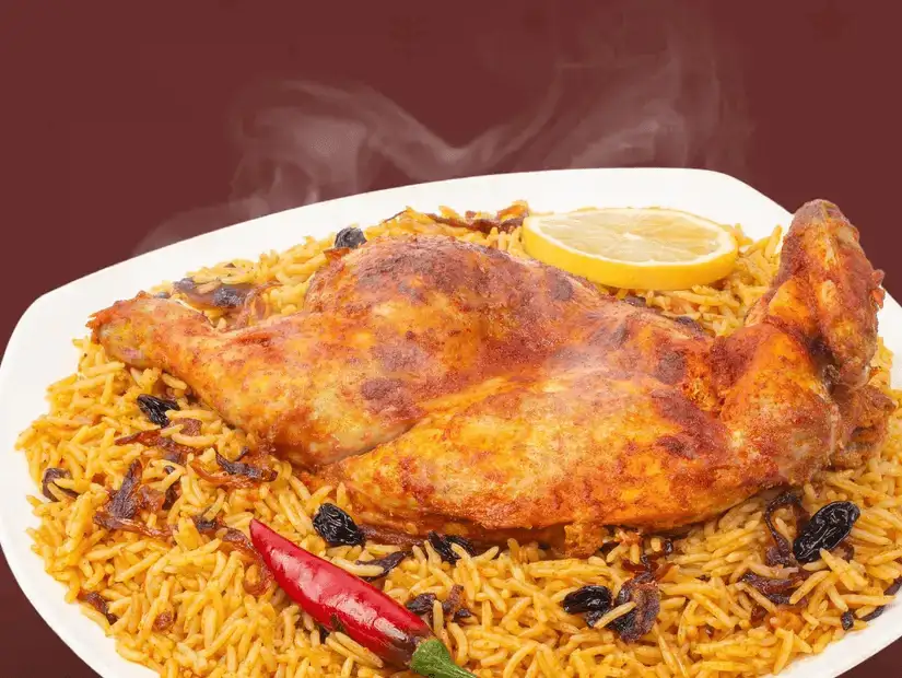 A platter of Mandi, a popular Arabian dish with slow-cooked meat over fragrant rice.