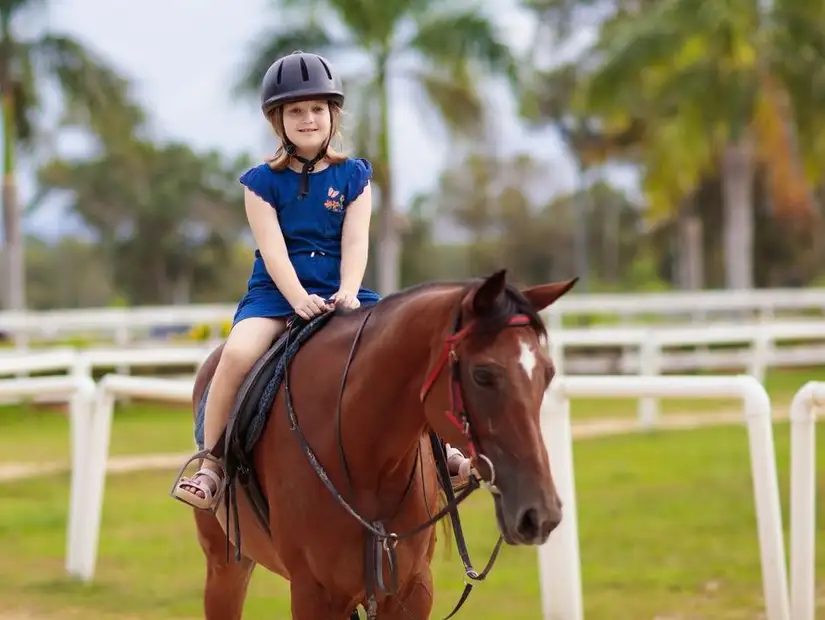 Young rider enjoying a calm horseback ride.