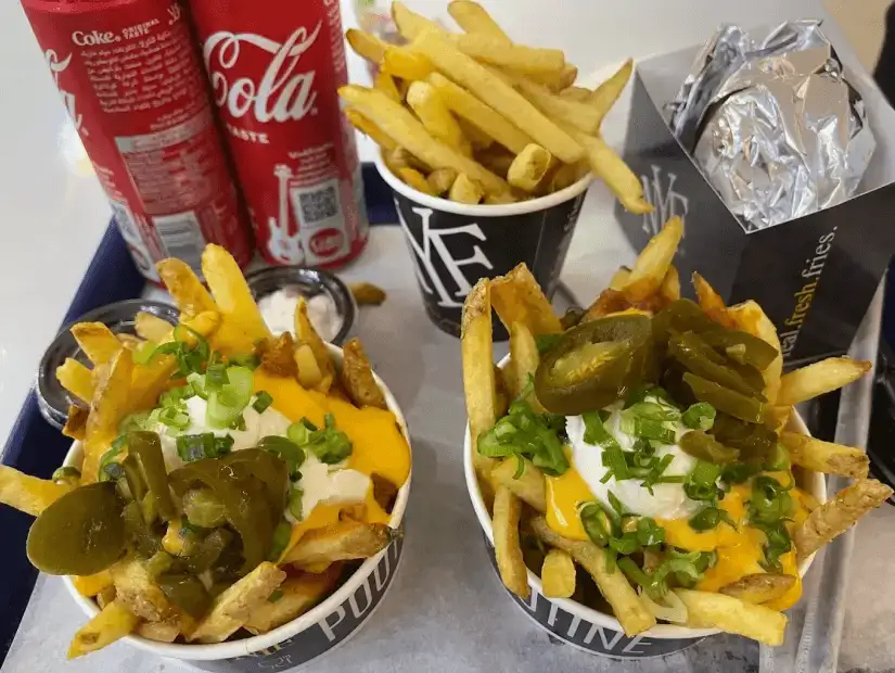 French fries topped with cheese and jalapenos.