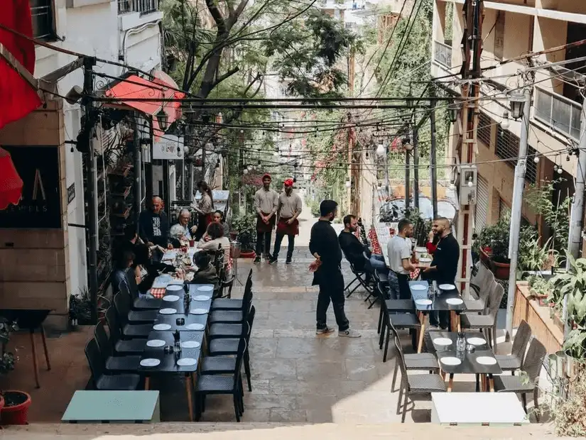 A lively scene at the Nicholas Stairs in Beirut, where outdoor seating and local cafes create a vibrant and social atmosphere.