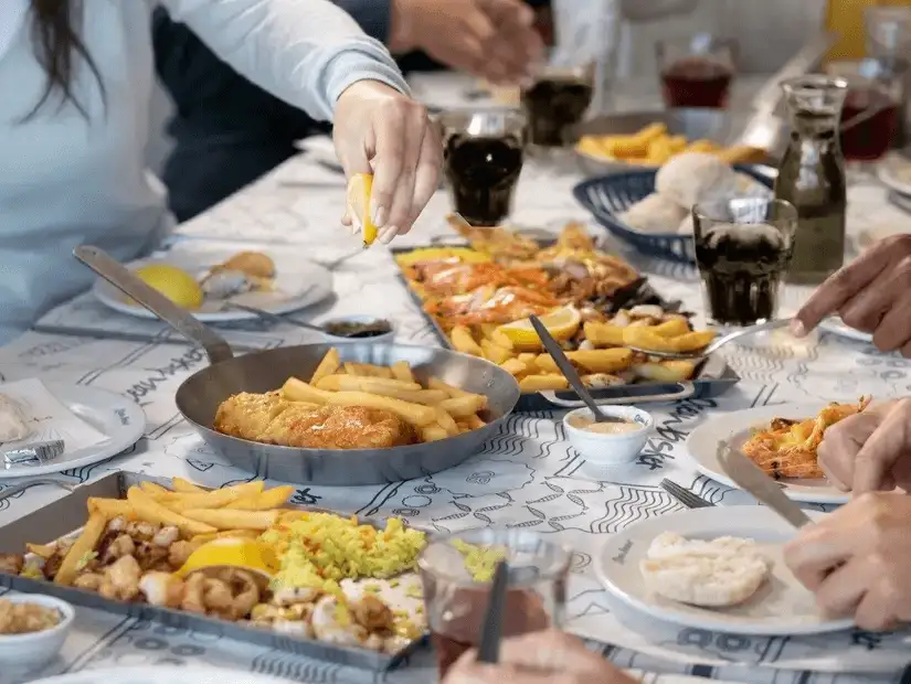 Family mealtime featuring a variety of dishes, perfect for sharing.