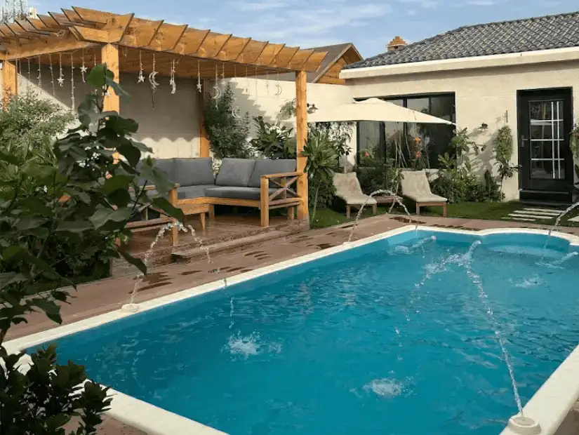 A wooden chalet with a warm and inviting appearance, featuring a comfortable seating area and garden.