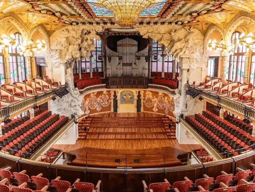 A dazzling concert hall in Barcelona with intricate design and stained glass.
