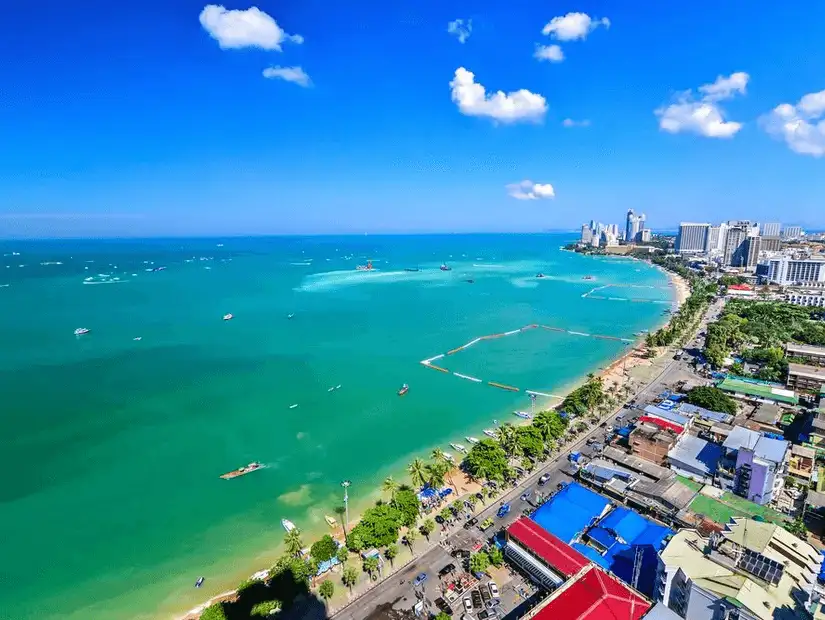 An expansive view of Pattaya Beach, with the city skyline in the distance.