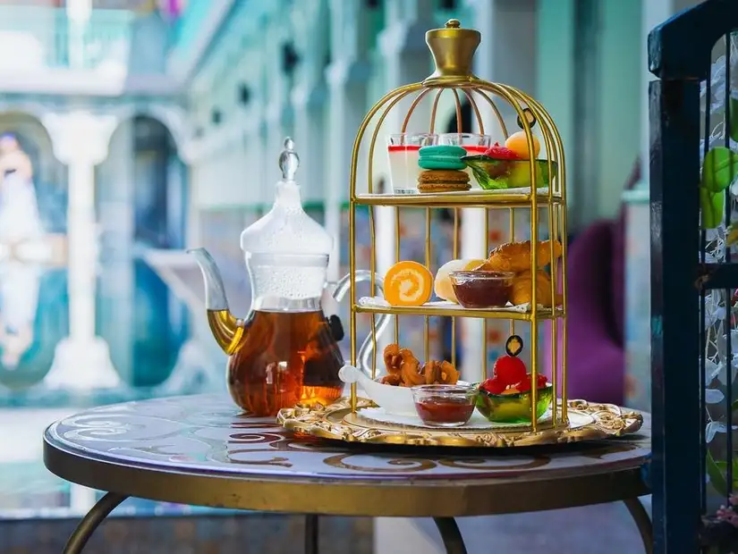 Afternoon tea elegantly presented with a range of pastries and fruits 