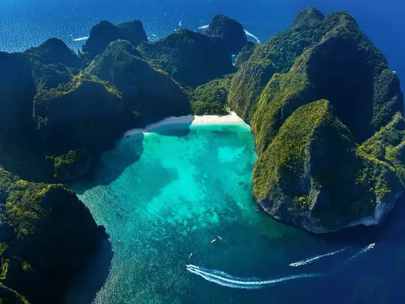 A breathtaking aerial view of the crystal-clear waters and towering cliffs of the Phi Phi Islands.