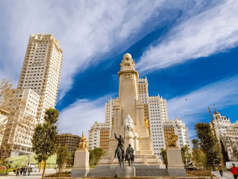 A grand square featuring the Cervantes Monument surrounded by iconic towers.