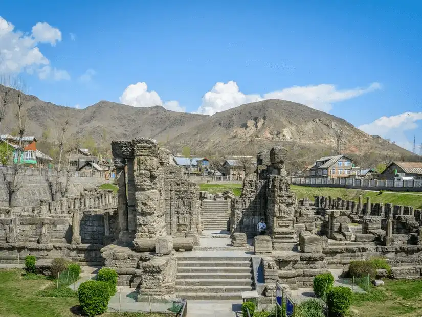 A scenic view of a valley surrounded by mountains, showcasing the natural beauty of Pulwama.