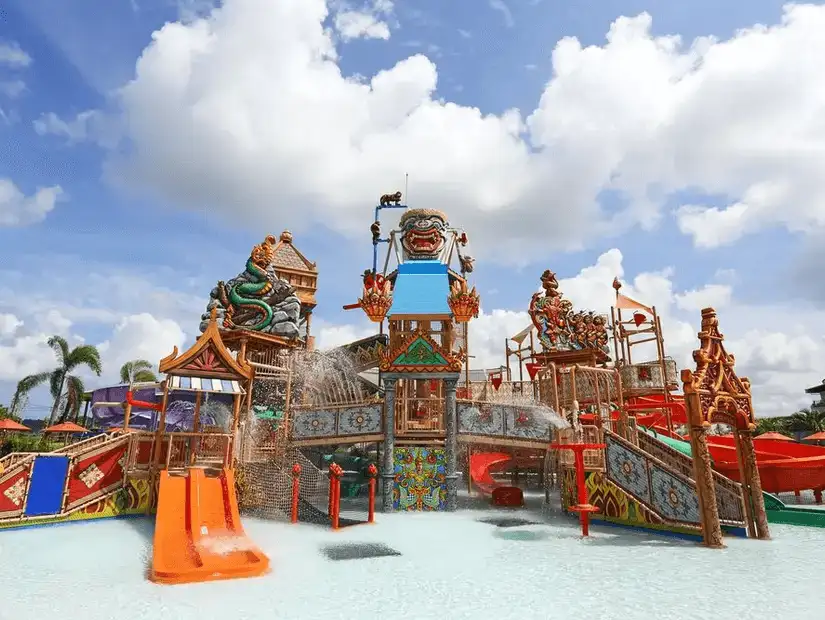 The vibrant and playful structures of Ramayana Water Park against a bright blue sky.