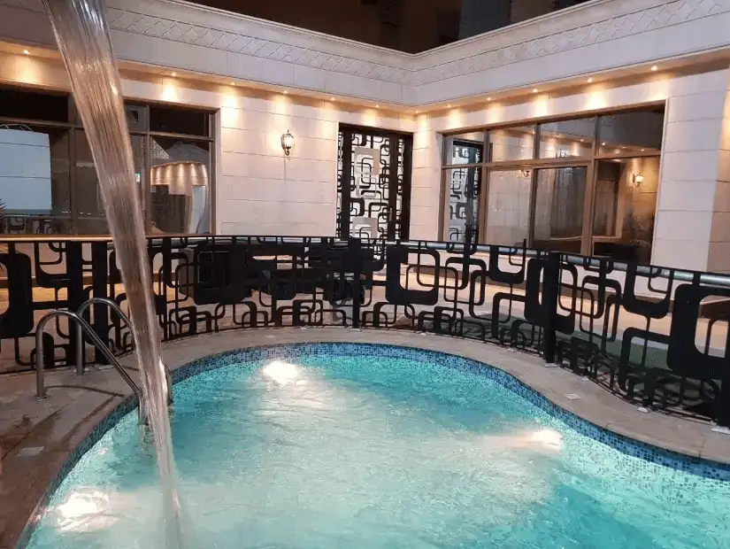 A charming pool area surrounded by a tranquil garden space.
