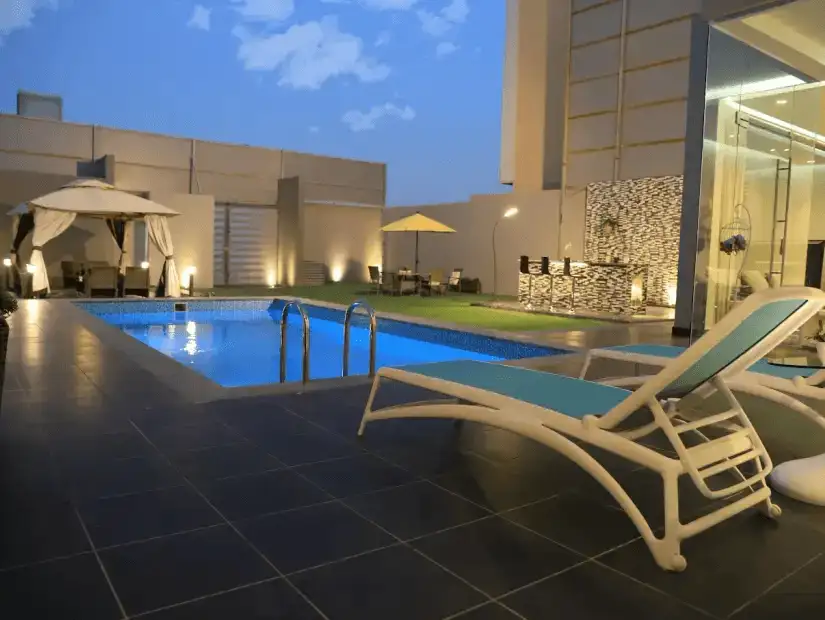 Comfortable poolside relaxation area with sunbeds and umbrellas.