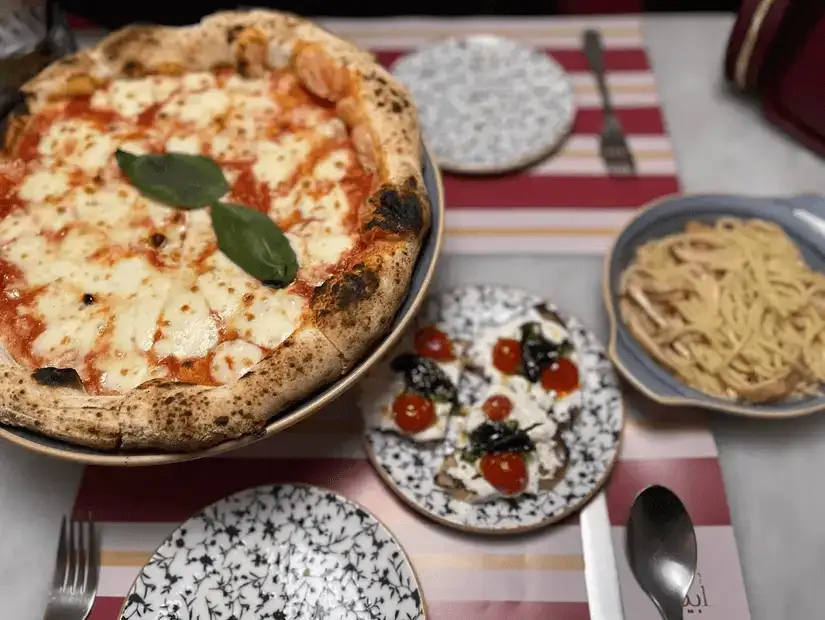 Classic Margherita pizza with fresh basil and tomatoes.