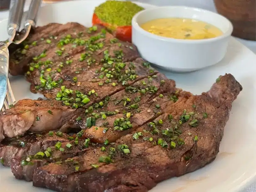 Juicy steak topped with herbs and served with dipping sauces.