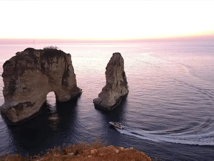 The magnificent Pigeon Rocks at Raouché, with the sun setting over the Mediterranean Sea.