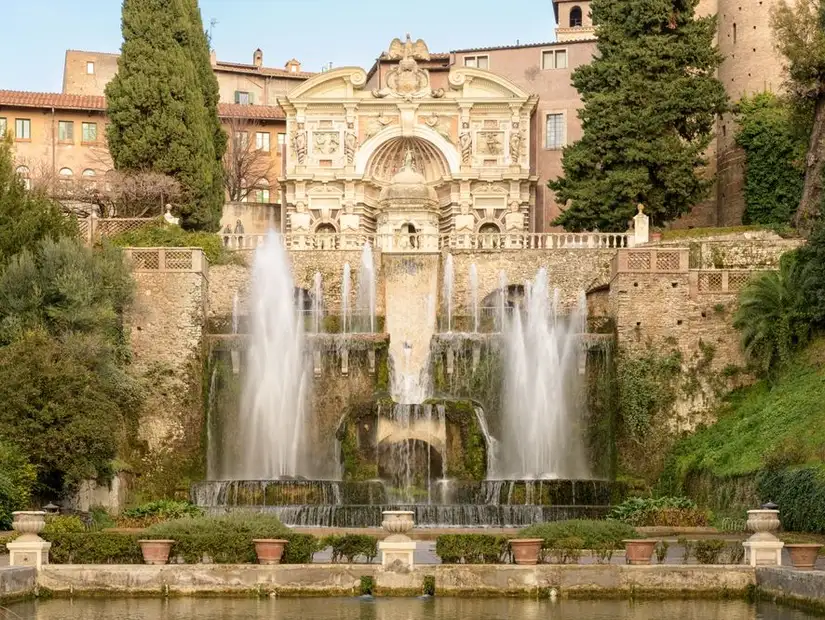 The grand fountains at the Villa d'Este, surrounded by lush greenery.