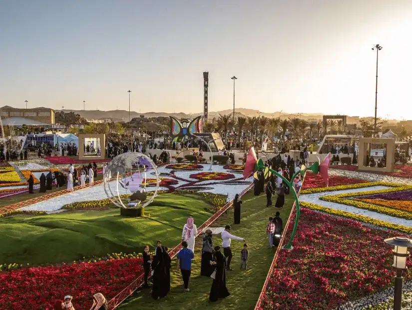 People enjoying a colorful flower festival at Rudaf Park.