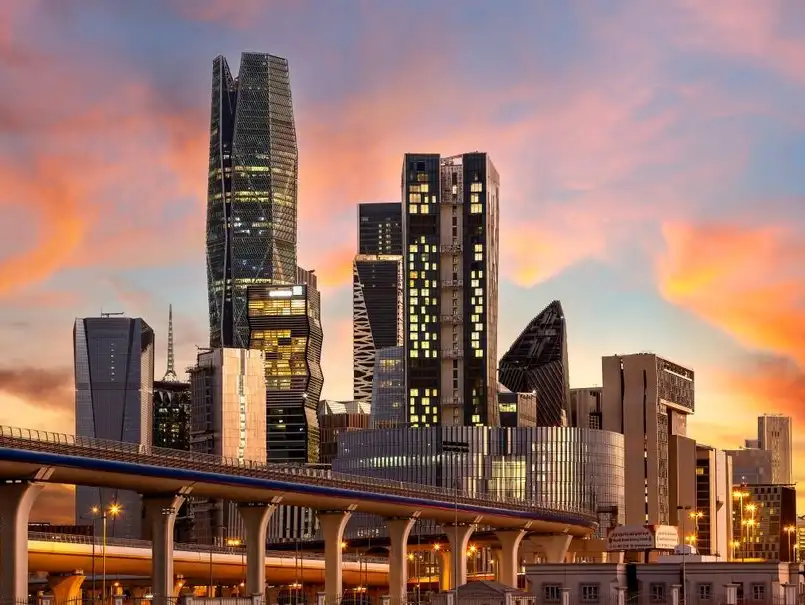 Sunset view of Riyadh’s modern architecture, capturing the dynamic shapes of skyscrapers against a vividly colored sky.