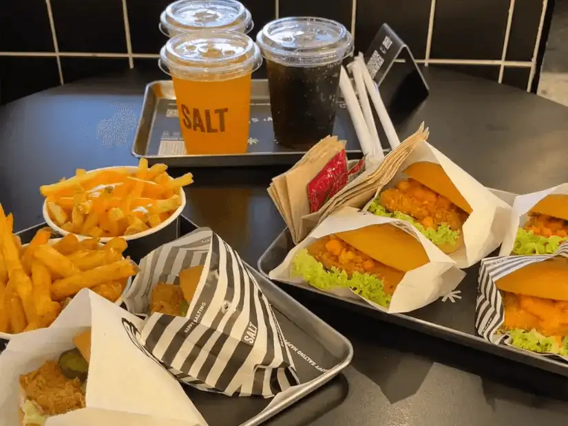 A fast food tray with fries, drinks, and sandwiches.