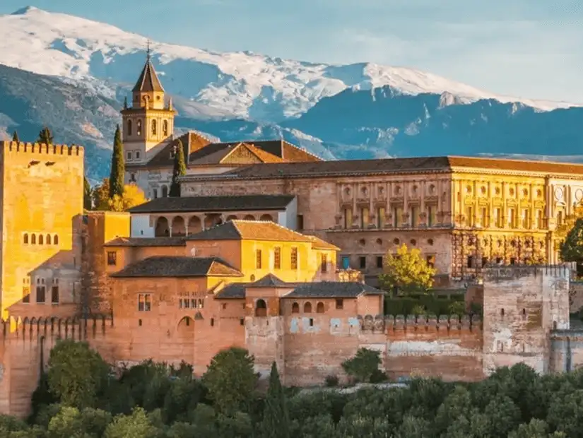 A stunning view of Alhambra set against snow-capped Sierra Nevada.