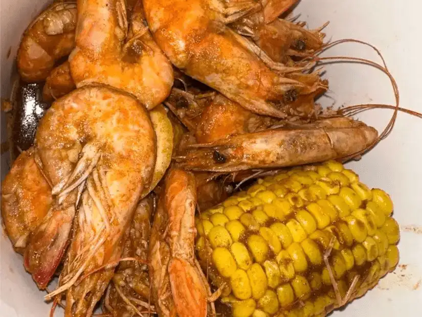 Juicy shrimp served with sweet corn in a spiced butter sauce.