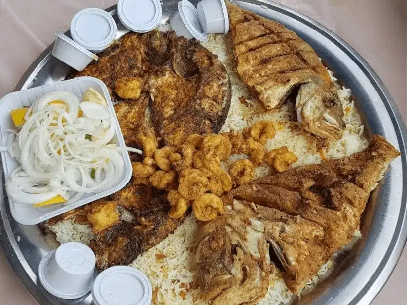 A seafood feast of fish, shrimp, and rice.