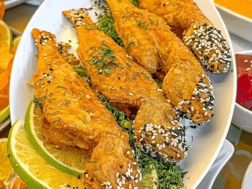 Crispy fried fish topped with sesame and dill.